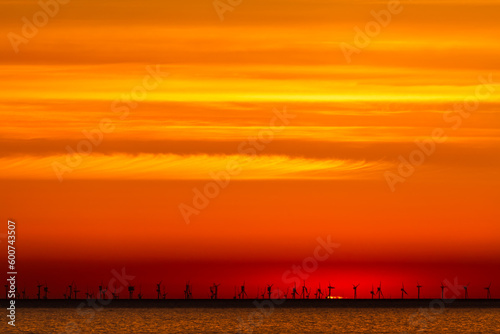 Sunrise over windfarm turbines in Wales