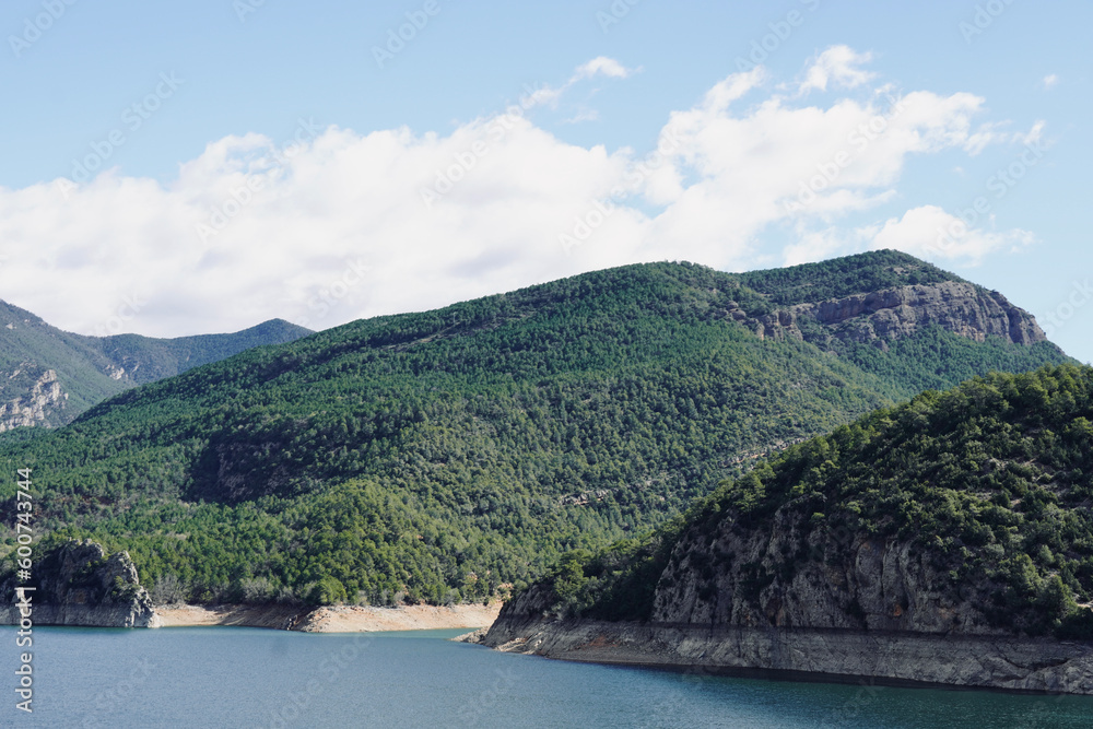 Oliana reservoir in Lleida, Catalonia. Mountains with blue sky in the background with space for text.