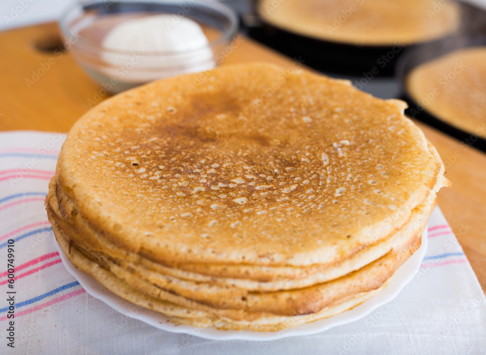 stack of appetizing flour pancakes in the kitchen during cooking stack of appetizing flour pancakes in the kitchen during cooking