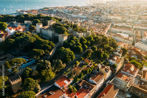 Aerial drone view of Castelo Sao Jorge on foreground with Lisbon, Portugal baixa district in background photo