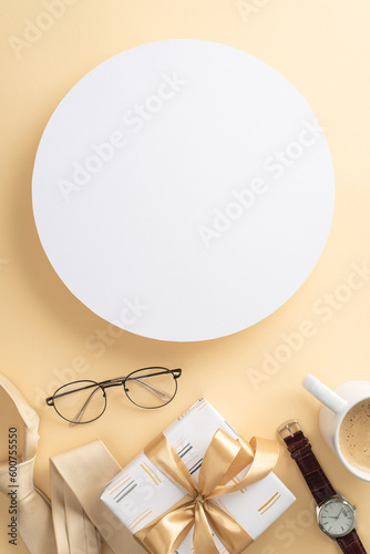 Impress Dad with a sophisticated Father's Day setup. Top vertical view of necktie, watch, glasses, giftbox, coffee cup, men's accessories, on a beige background with a blank circle for text or ad