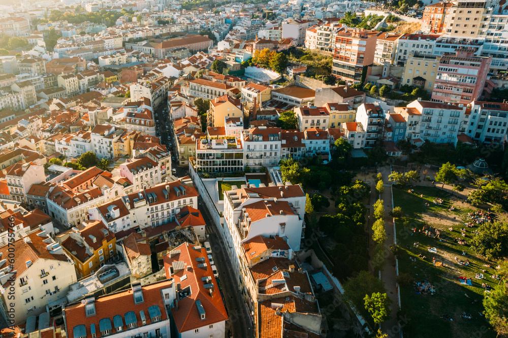 Obraz premium Aerial drone view of apeople at two viewpoints overlooking Lisbon, Portugal at sunset