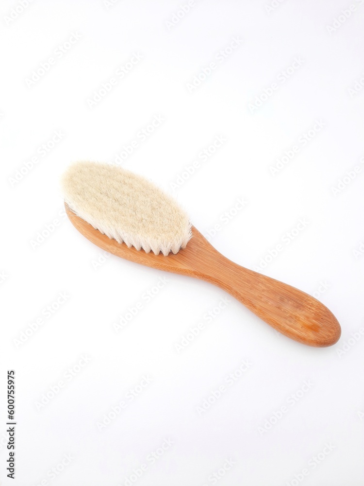 Hair brush isolated on white background. Baby hair brush that is soft and safe to use on baby's head Hair brush isolated on white background. Baby hair brush that is soft and safe to use on baby's head