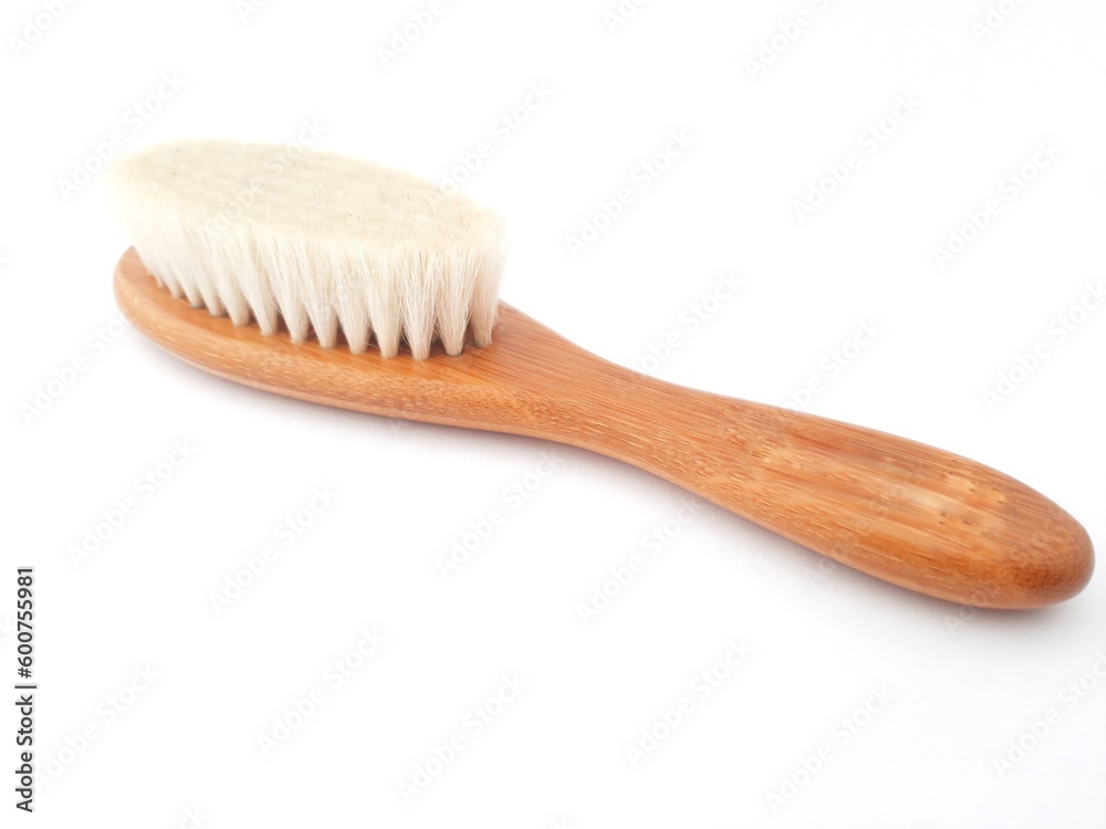 Hair brush isolated on white background. Baby hair brush that is soft and safe to use on baby's head Hair brush isolated on white background. Baby hair brush that is soft and safe to use on baby's head