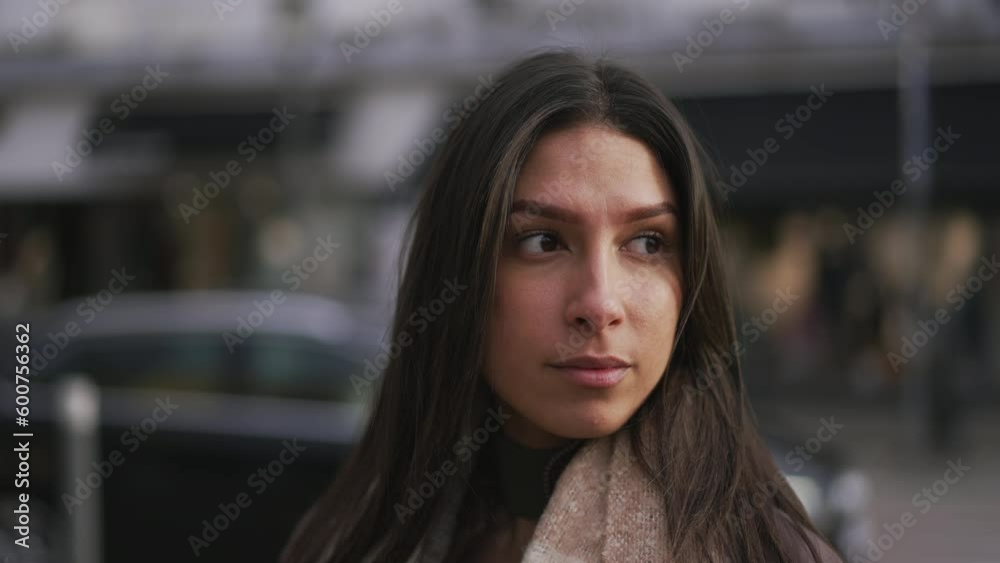 Portrait of a beautiful young woman from Middle Eastern ethnicity standing in city street. Tracking shot in motion of a female person in 20s closeup face Portrait of a beautiful young woman from Middle Eastern ethnicity standing in city street. Tracking shot in motion of a female person in 20s closeup face