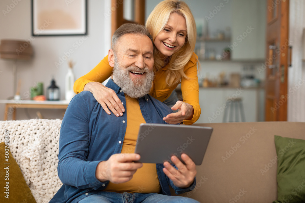 Senior Couple Enjoying Digital World Using Tablet Computer At Home Senior Couple Enjoying Digital World Using Tablet Computer At Home