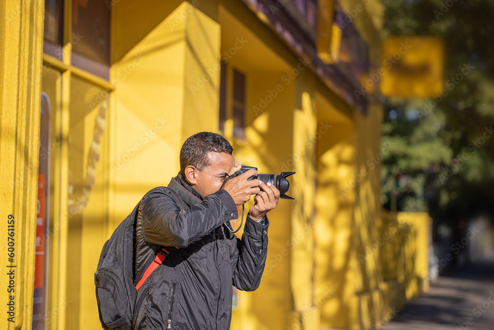 Latino photographer taking a picture with his camera with copy space. Latino photographer taking a picture with his camera with copy space.