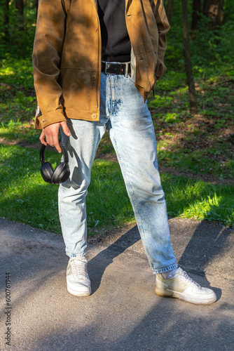 A man holding the headphones in his hands.