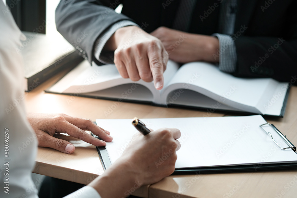 Legal counsel presents to the client a signed contract with gavel and legal law. justice and lawyer concept. Legal counsel presents to the client a signed contract with gavel and legal law. justice and lawyer concept.