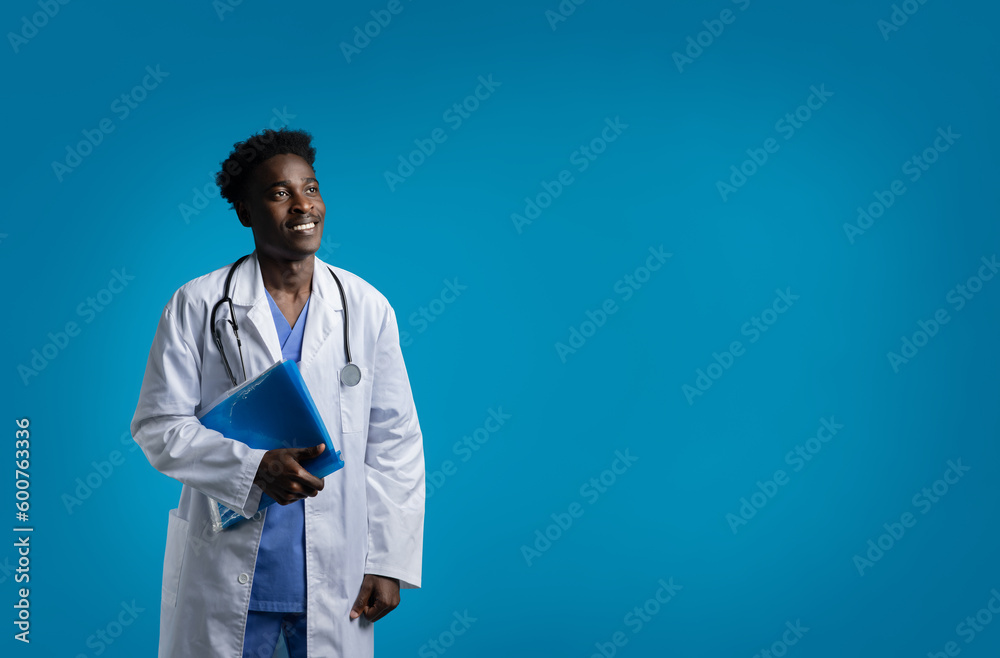 Cheerful young black doctor with medical chart, copy space Cheerful young black doctor with medical chart, copy space