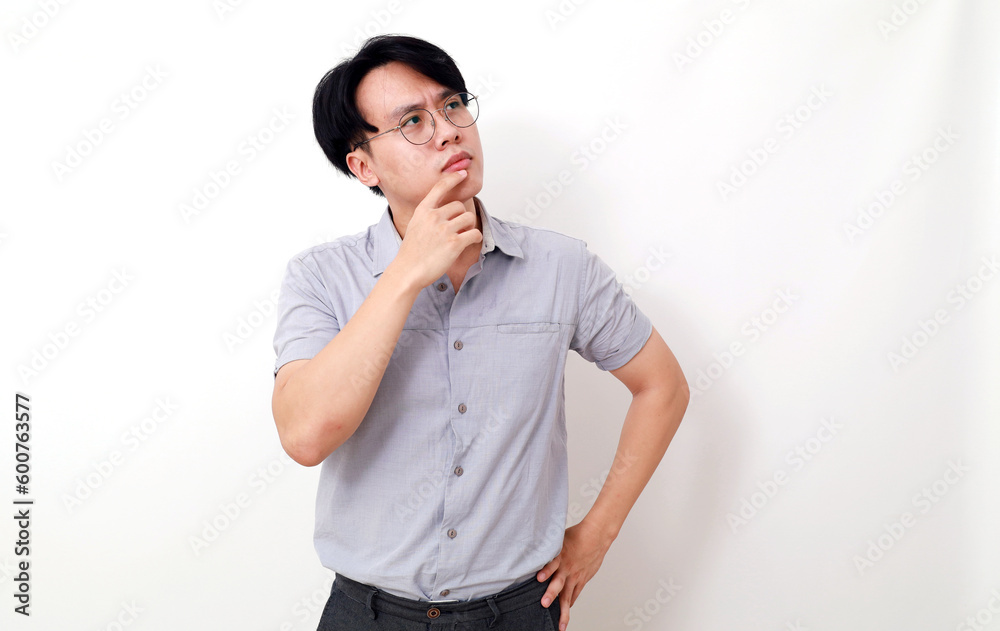 Confused asian man thinking something while looking above. Isolated on white background Confused asian man thinking something while looking above. Isolated on white background