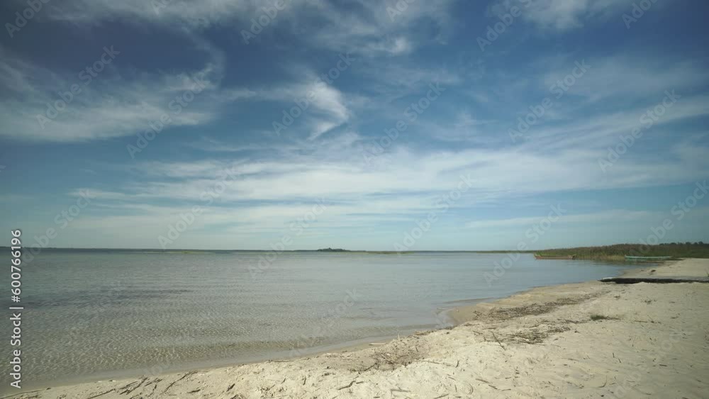 Beautiful landscape with shore, beach, fishing wooden boats and island on a sunny day of Svityaz lake, Ukraine Beautiful landscape with shore, beach, fishing wooden boats and island on a sunny day of Svityaz lake, Ukraine