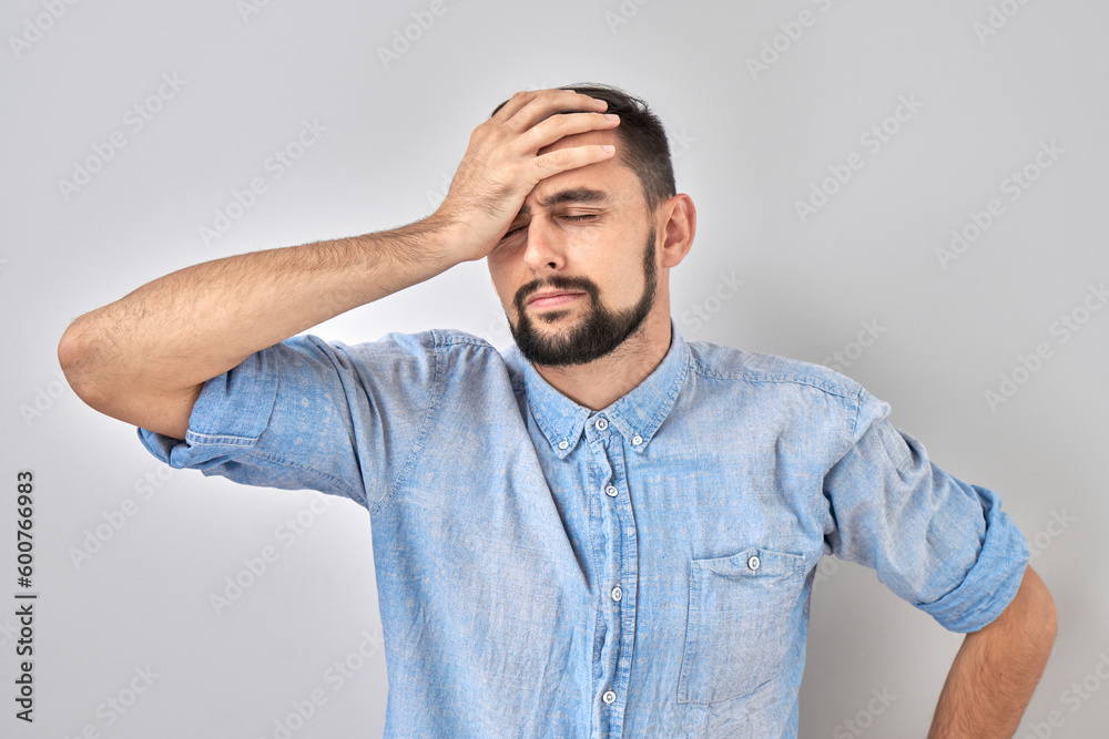 Portrait sad brunette young man put his hand on forehead isolated on white studio background. Made mistake, upset and depressed. Portrait sad brunette young man put his hand on forehead isolated on white studio background. Made mistake, upset and depressed.