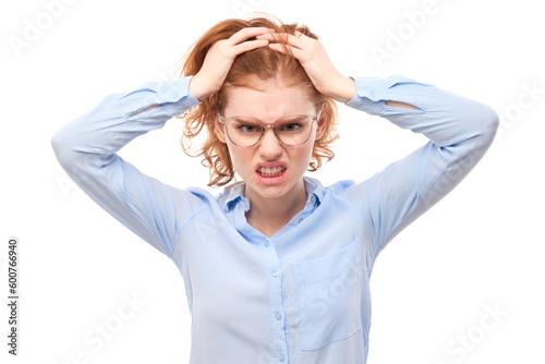 Portrait angry redhead young woman screaming isolated on white studio background, showing negative emotions.