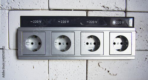 A gray electrical outlet unit built into the wall