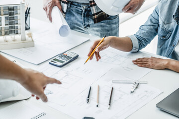 Architects interior designer hands working with Blue prints and documents for a home renovation for house design.