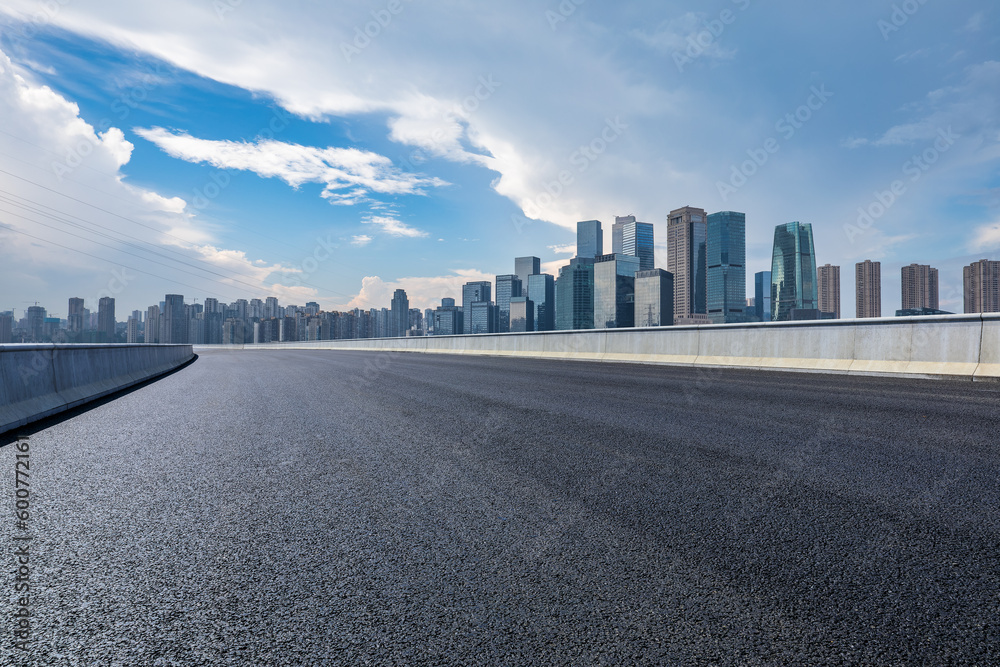 Asphalt road and urban skyline with modern buildings background Asphalt road and urban skyline with modern buildings background
