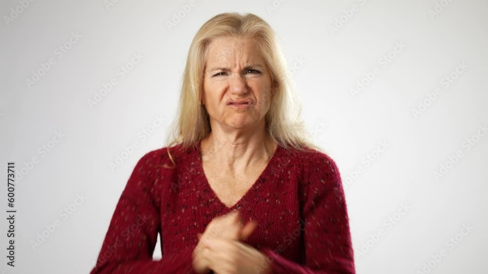 Portrait of frustrated, angry, mature woman with funny face isolated on white background in studio. People sincere emotions, lifestyle concept. Portrait of frustrated, angry, mature woman with funny face isolated on white background in studio. People sincere emotions, lifestyle concept.