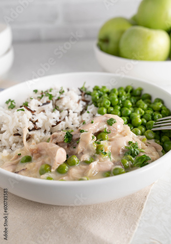 Fotografie Chicken fricassee with basmati, wild rice and buttered green peas on a plate