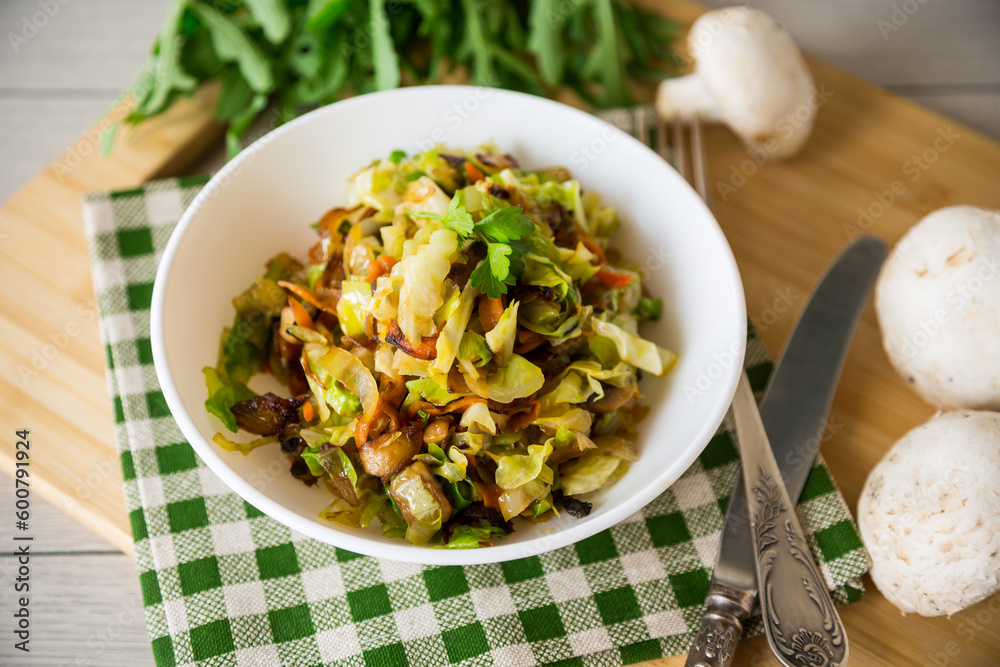 cabbage early fried with mushrooms, carrots and vegetables cabbage early fried with mushrooms, carrots and vegetables