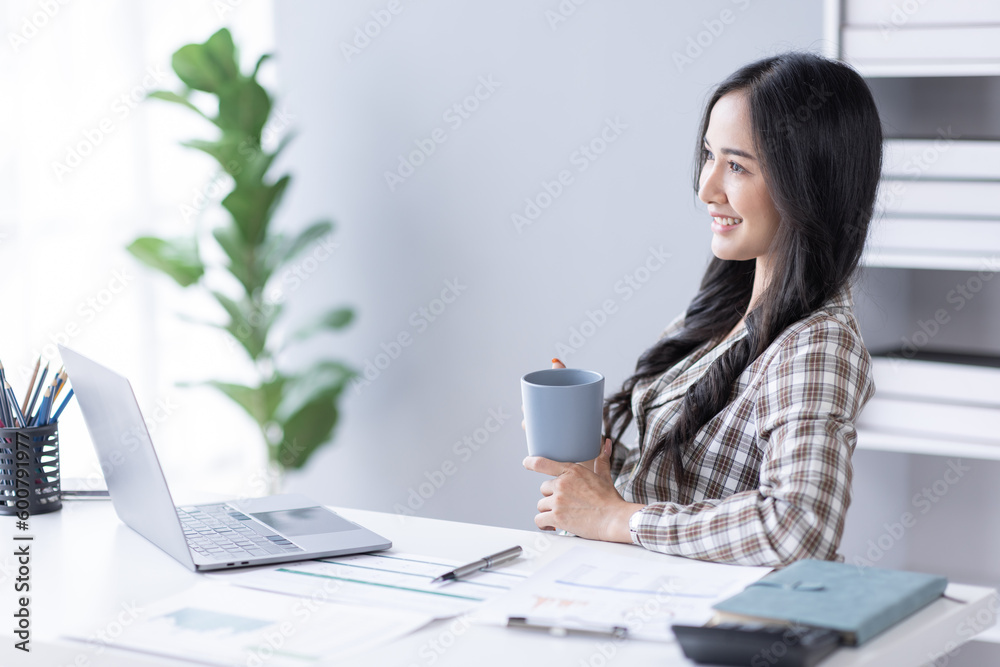Portrait of Asian business woman holding coffee cup with work in workplace office Business documents money financial planning concept Portrait of Asian business woman holding coffee cup with work in workplace office Business documents money financial planning concept