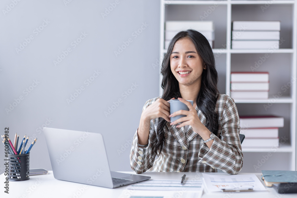 Portrait of Asian business woman holding coffee cup with work in workplace office Business documents money financial planning concept Portrait of Asian business woman holding coffee cup with work in workplace office Business documents money financial planning concept