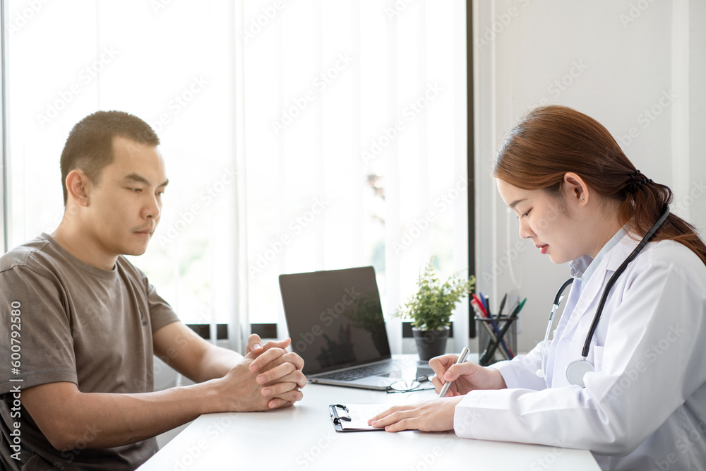 The doctor is explaining the treatment method to the male patient in the hospital. The doctor is explaining the treatment method to the male patient in the hospital.