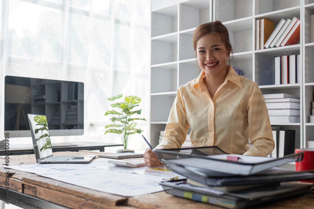 Business woman using calculator for do math finance on wooden desk in office and business working background, tax, accounting, statistics and analytic research concept.. Business woman using calculator for do math finance on wooden desk in office and business working background, tax, accounting, statistics and analytic research concept..