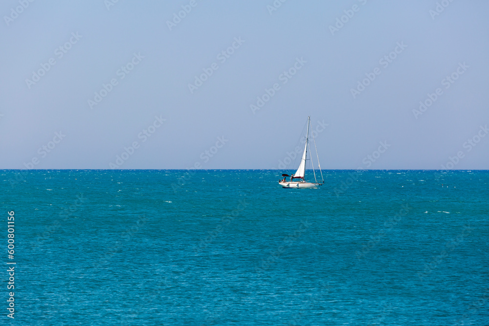 A sailboat is sailing in the ocean
