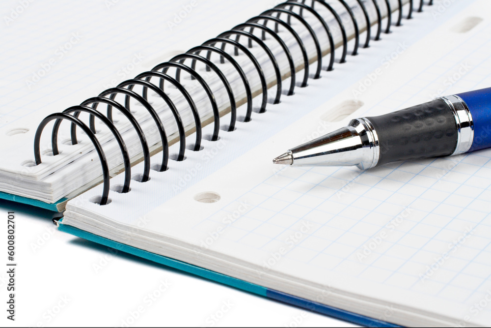 Detail of pen and notebook with shadow over a white background Detail of pen and notebook with shadow over a white background
