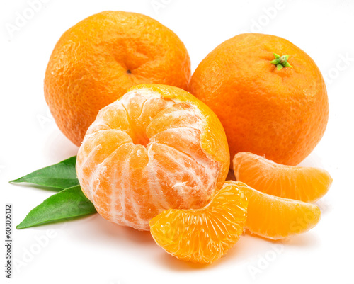 Ripe mandarin fruits with leaf and mandarin slices on white background.