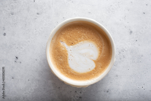 A top down view of a coffee cup with latte art.