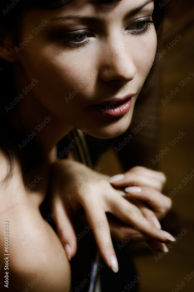 Mysterious low-key portrait of beautiful glamorous woman. Soft-focused. Focus is on eye Mysterious low-key portrait of beautiful glamorous woman. Soft-focused. Focus is on eye