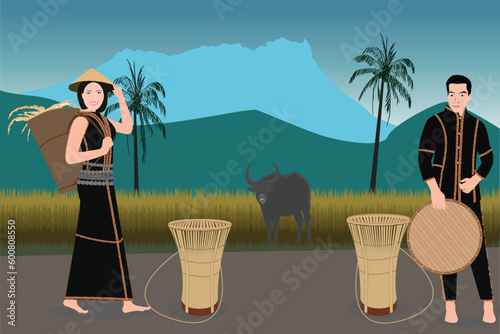 a man and a woman dressed in traditional costumes during paddy harvesting season. Bamboo handicrafts used for harvesting paddy are easily found in the villages photo