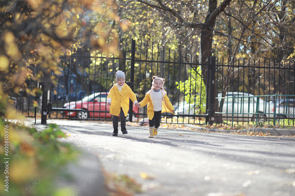 Children walk in the autumn park Children walk in the autumn park