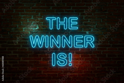 The winner is, neon sign. Brick wall with the text "The Winner Is" in blue neon letters. Announcement message, success, champion, trophy, achievement and inspiration concept. 3D illustration