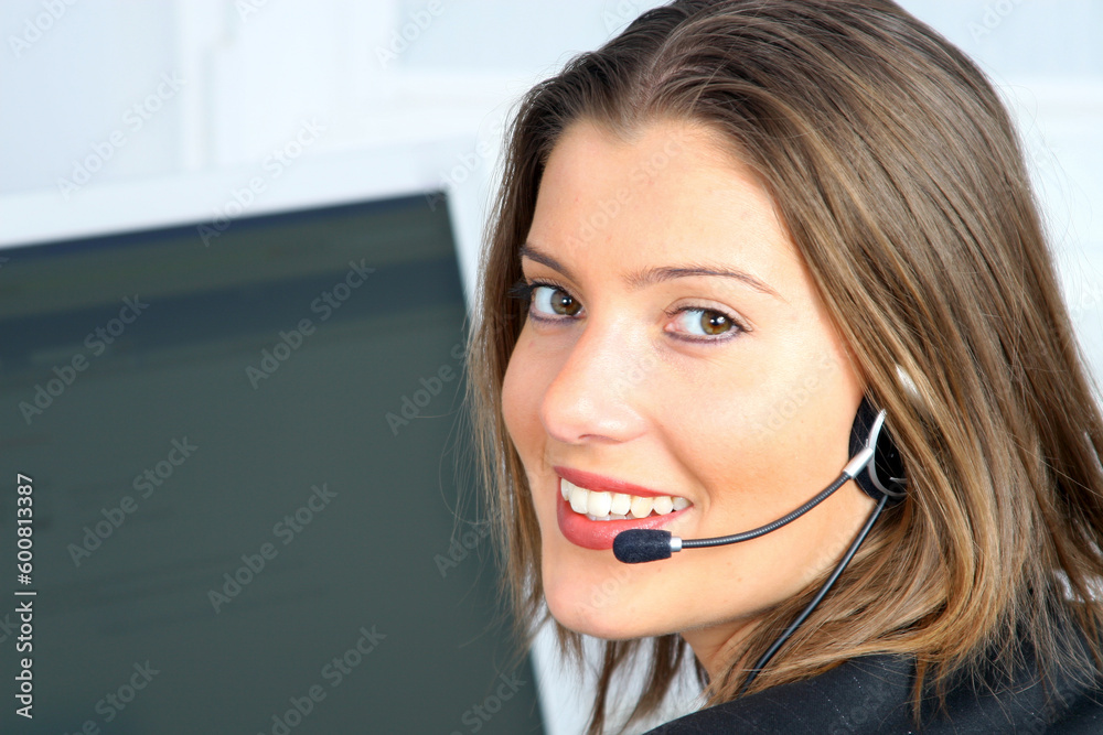 young woman on customer service with computer in background young woman on customer service with computer in background