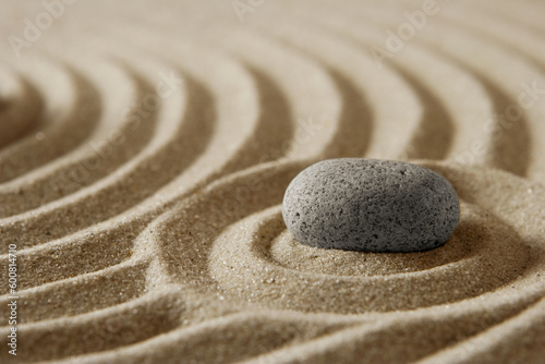 Close-up stone on raked sand; zen cocept