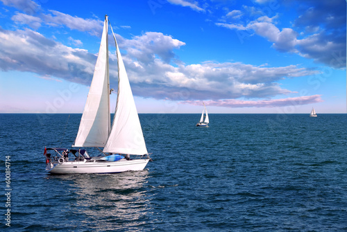 Fototapeta Naklejka Na Ścianę i Meble -  Sailboat sailing in the morning with blue cloudy sky