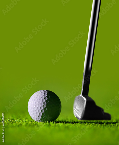 Golf Stick and Ball on the Green Grass with green background