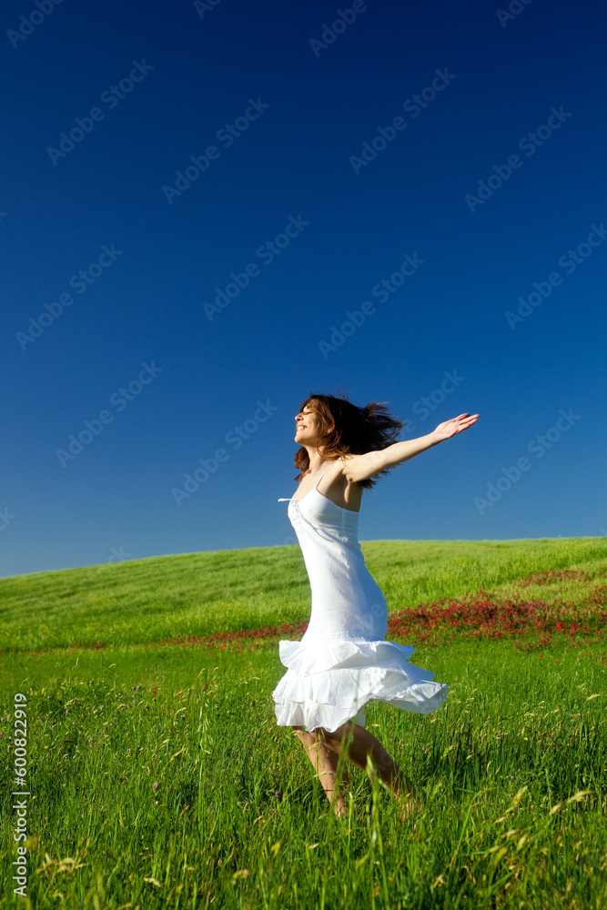Beautiful happy young woman dancing on the field Beautiful happy young woman dancing on the field
