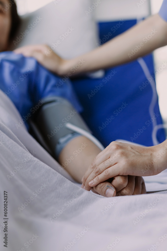 doctor check up after surgery. doctor touching patient hand and consoling. doctor check up after surgery. doctor touching patient hand and consoling.