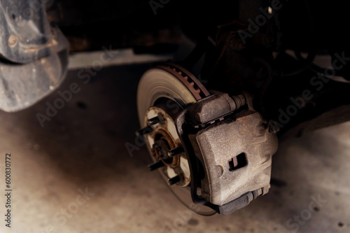 old braking system. close-up of repair. replacement brake disc and pad. car maintenance service. car repairs