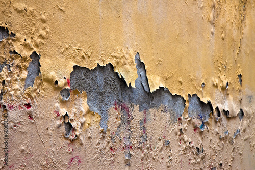 Old damaged and damp cement plaster that detaches from the masonry support photo