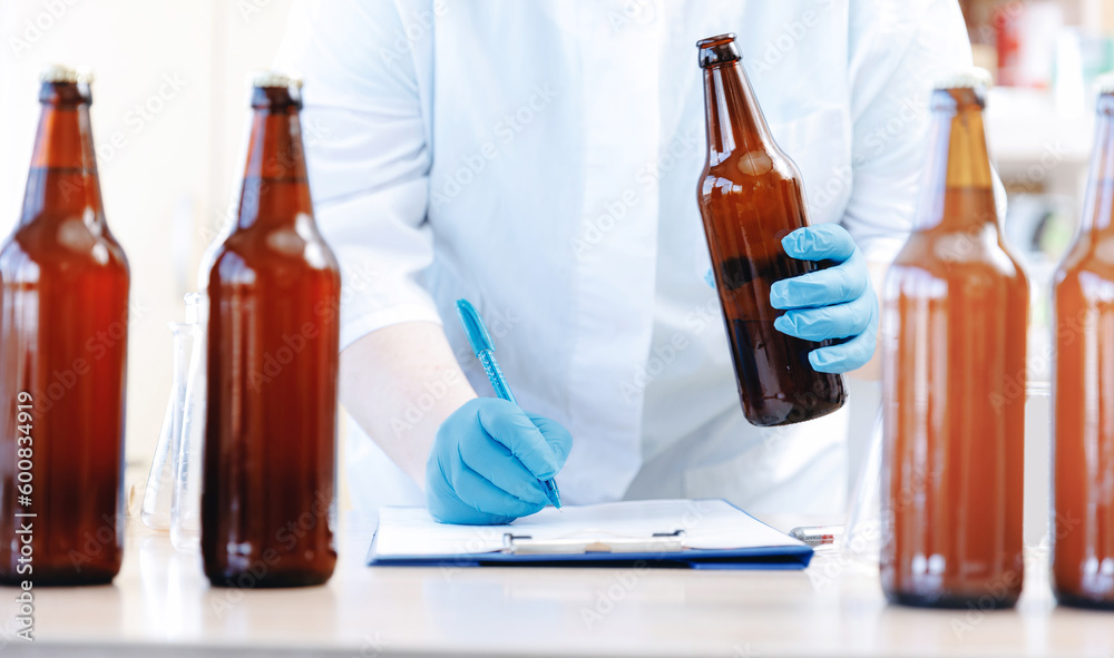Concept brewery industry banner. Factory worker of laboratory testing beer, analysis drink in glasses Concept brewery industry banner. Factory worker of laboratory testing beer, analysis drink in glasses