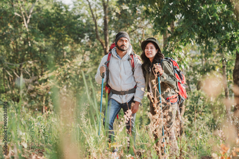 Travelers hiking with backpack traveling in forest wild and look around and explore while walking in nature wood. happy holiday vacation trip. Travelers hiking with backpack traveling in forest wild and look around and explore while walking in nature wood. happy holiday vacation trip.