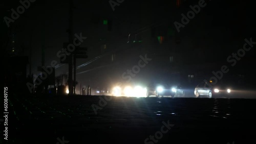 Blackout in the center of Kyiv after the shelling of a critical information structure. The city is completely dark, only the headlights of cars are visible.