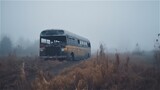 empty burnt bus on the road in a field in the fog. Generated ai.
