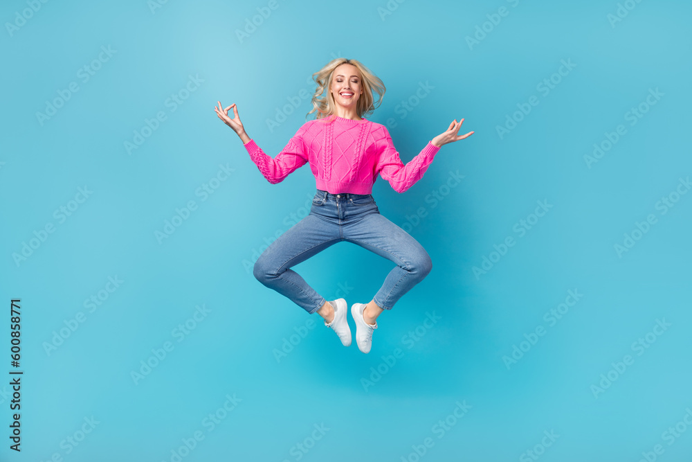 Full body photo of young relaxed closed eyes woman jumping balance asana meditation concentrated herself isolated on blue color background