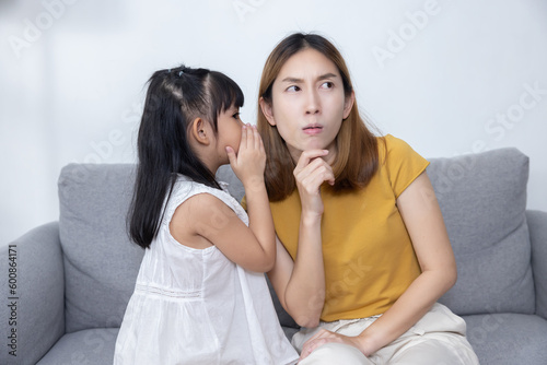 Little Girl Whisper a Secret to Her Mother Ear